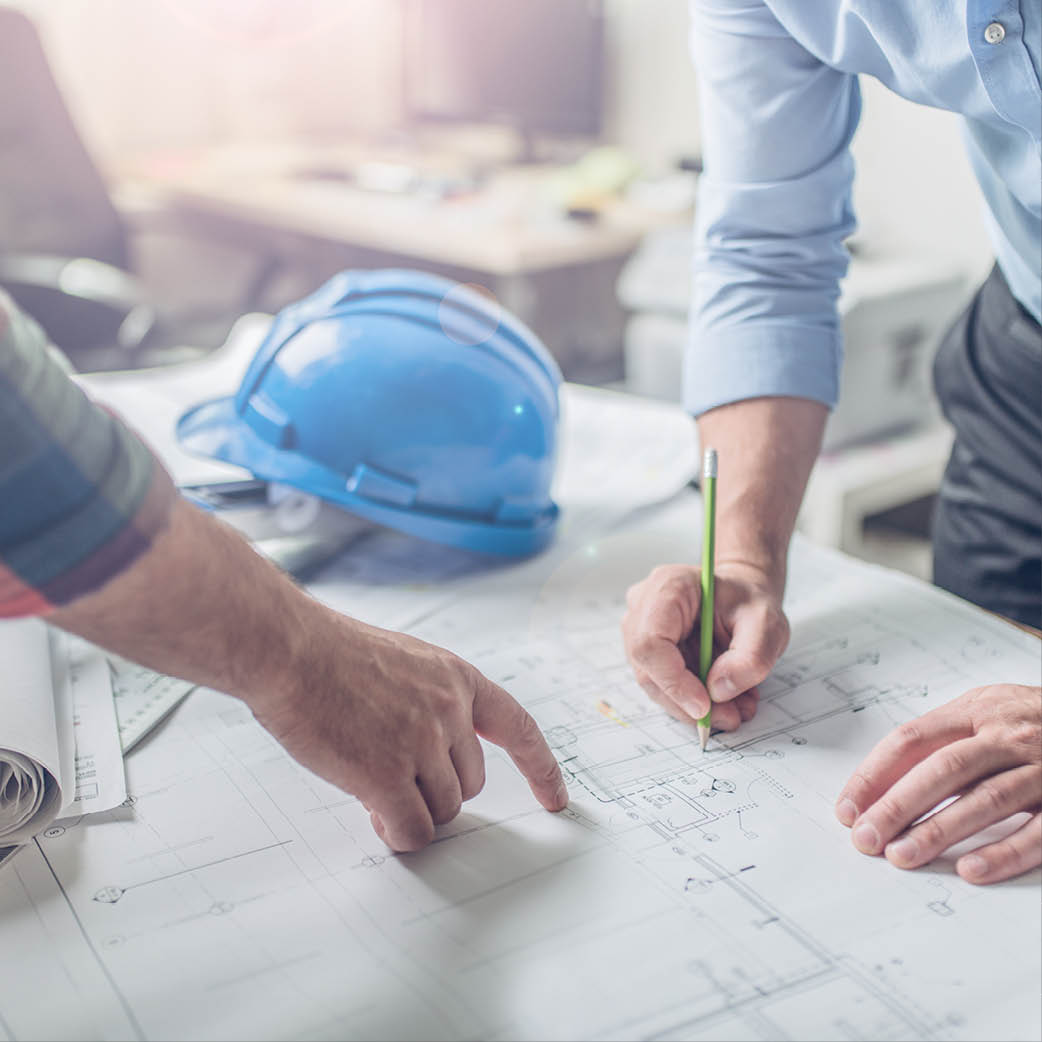 Construction workers looking at a blueprint